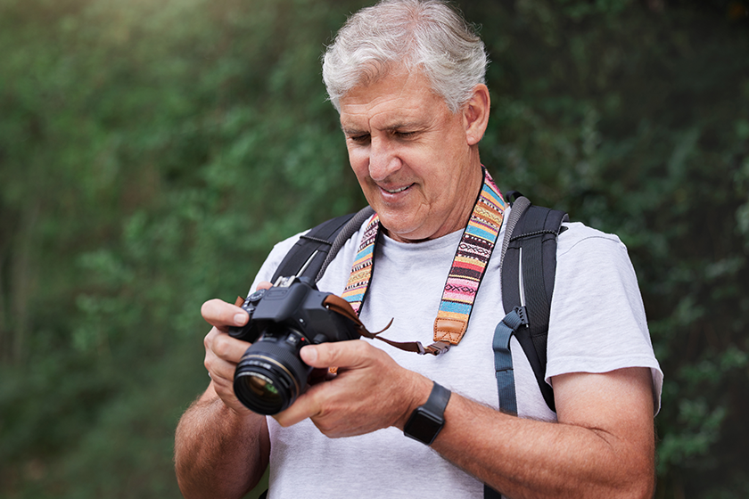 mature caucasian man taking pictures