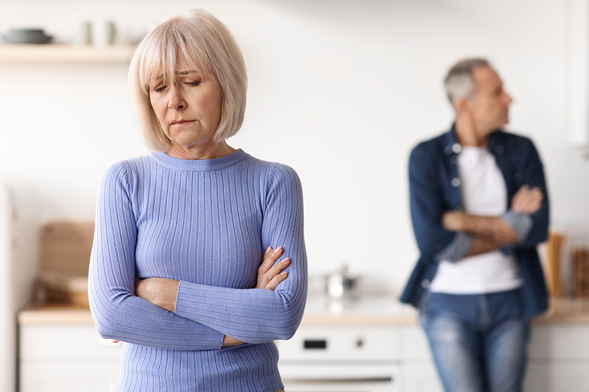 selective focus upset senior woman arms crossed chest looking aside