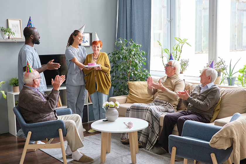 Senior people with nurse celebrating birthday